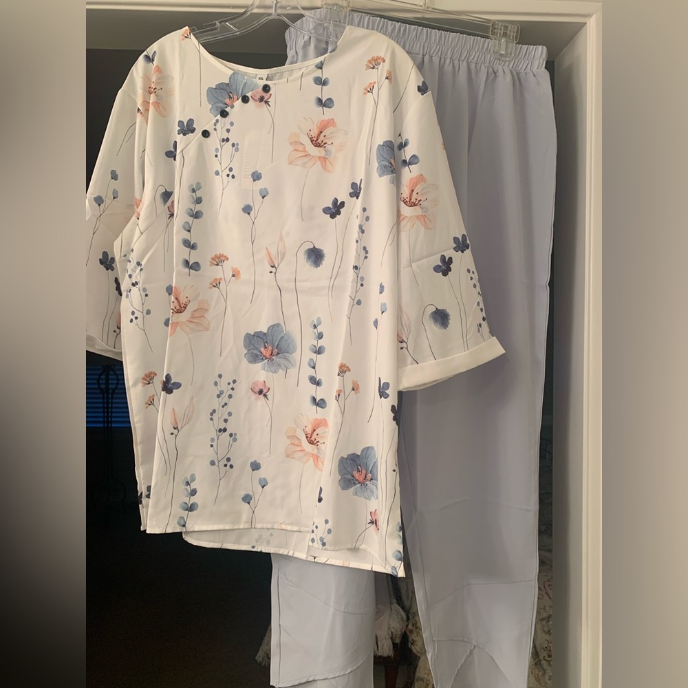 Two piece set. Short sleeve floral shirt with light blue pants. Brand: Nnesi